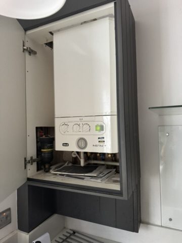 Boiler neatly installed in a kitchen cupboard