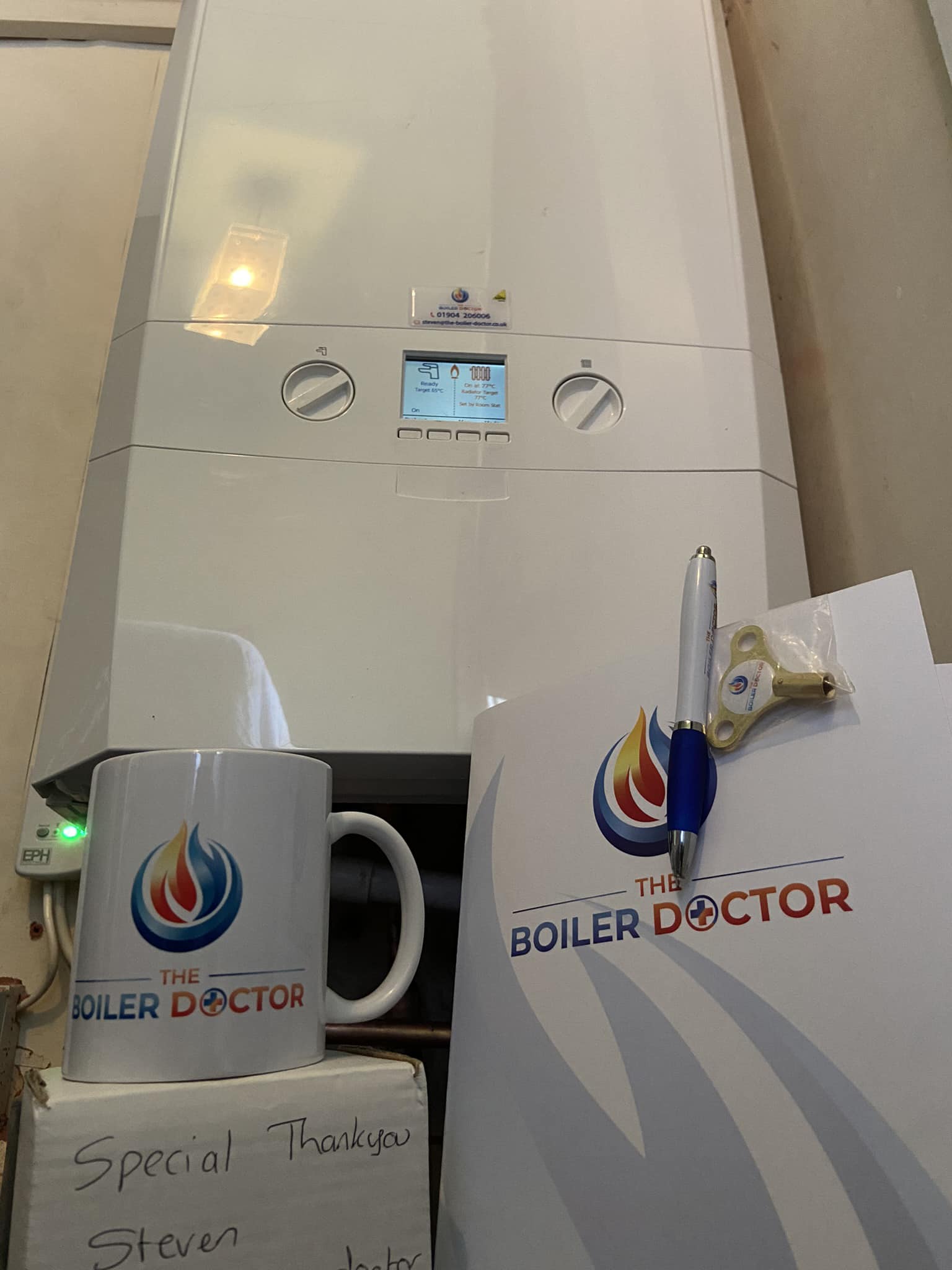 Steve pointing at newly installed boiler